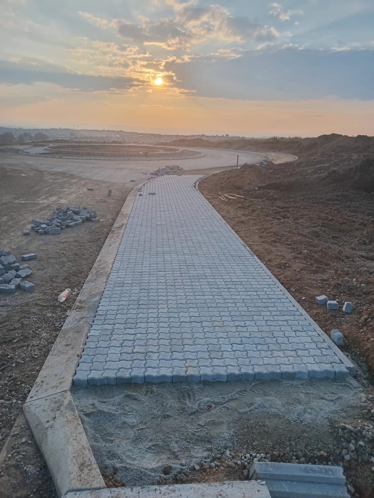 Paved pedestrian walkway constructed with grey interlocking paving stones